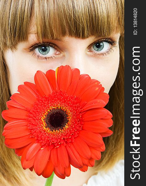 Portrait of a young woman with red flower gerbera