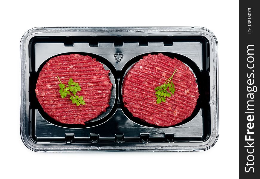Burger patties in a supermarket packaging tray isolated on a white background. Burger patties in a supermarket packaging tray isolated on a white background