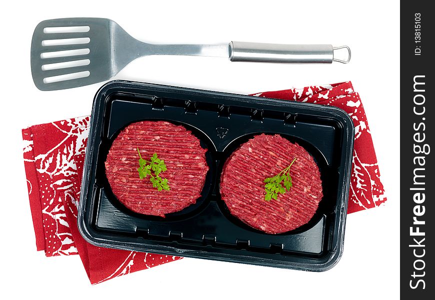 Burger patties in a supermarket packaging tray isolated on a white background. Burger patties in a supermarket packaging tray isolated on a white background