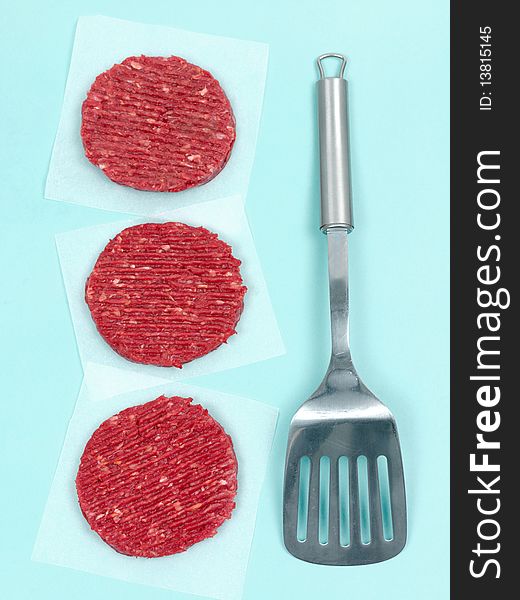 Burger patties isolated on a pale blue background. Burger patties isolated on a pale blue background