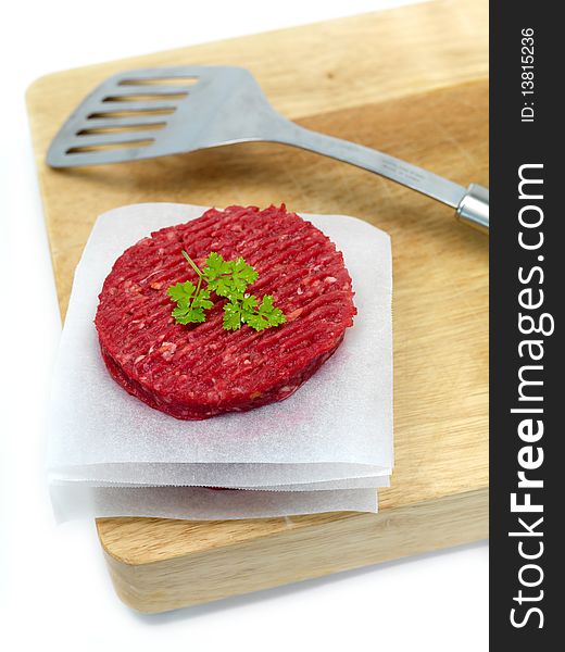 Burger patties isolated on a chopping board. Burger patties isolated on a chopping board