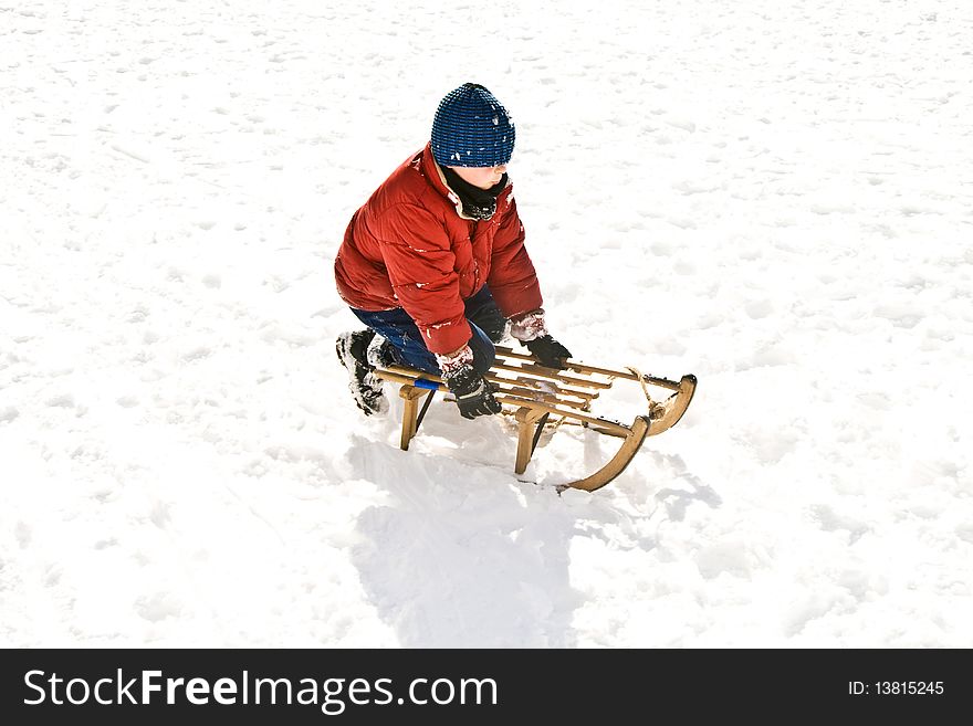 Young Boy Sledding Down The Hill