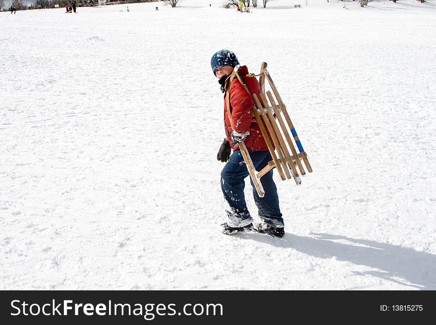 Young Boy Carries The Sledge