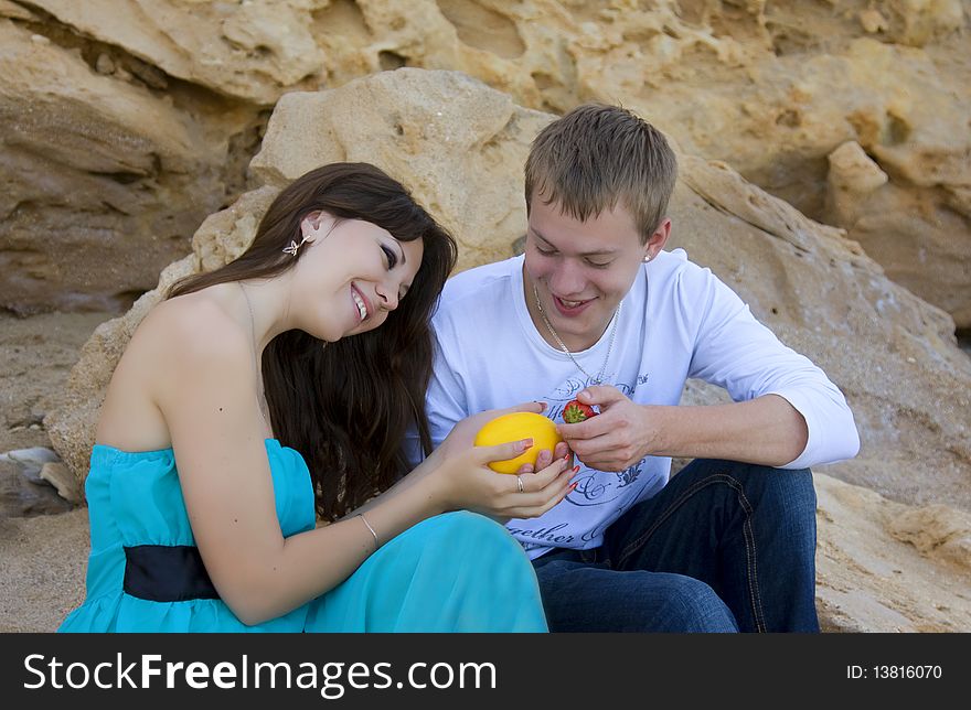 Yang woman and man enjoying themselves on the beach. Yang woman and man enjoying themselves on the beach