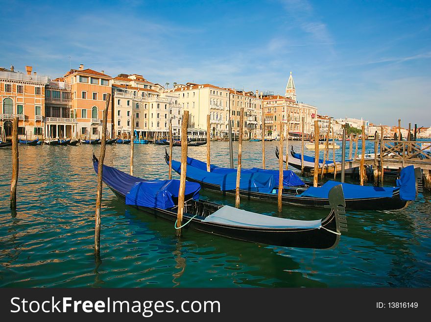 Group of gondolas docked on the water in Venice, Italy