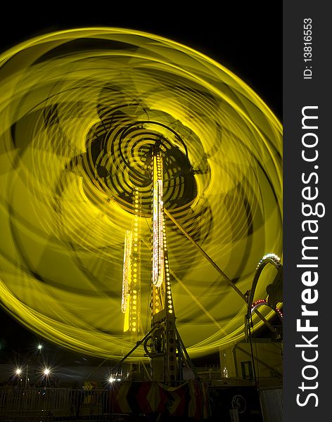 Long exposure shot of a ride at a fair glowing lights. Long exposure shot of a ride at a fair glowing lights