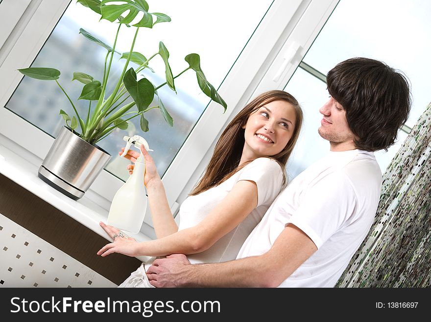 Girl with boy and flower in pot