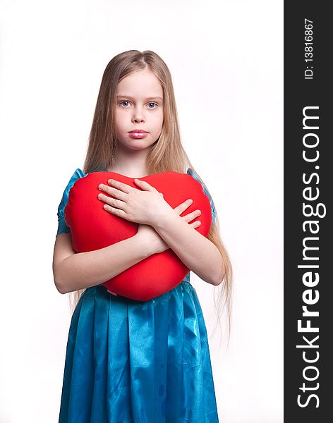 Beautiful young girl isolated on white, child with blond long hair, blue dress and red ball, studio. Beautiful young girl isolated on white, child with blond long hair, blue dress and red ball, studio