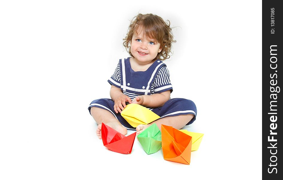 Cute toddler girl with paper ships