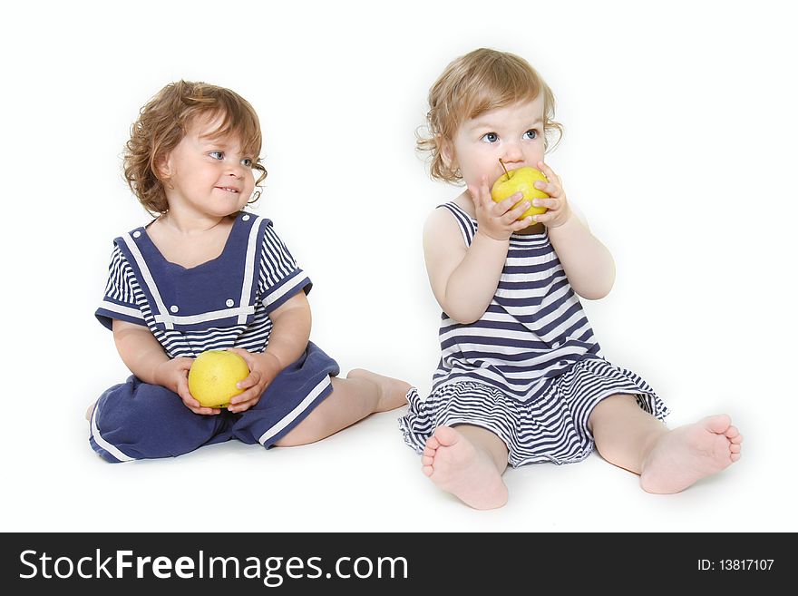 Two toddler girls with green apples over white