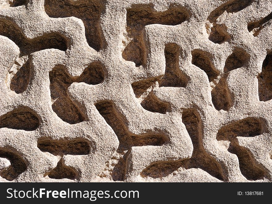 Close up of a maze-like wall feature on a building. Close up of a maze-like wall feature on a building.