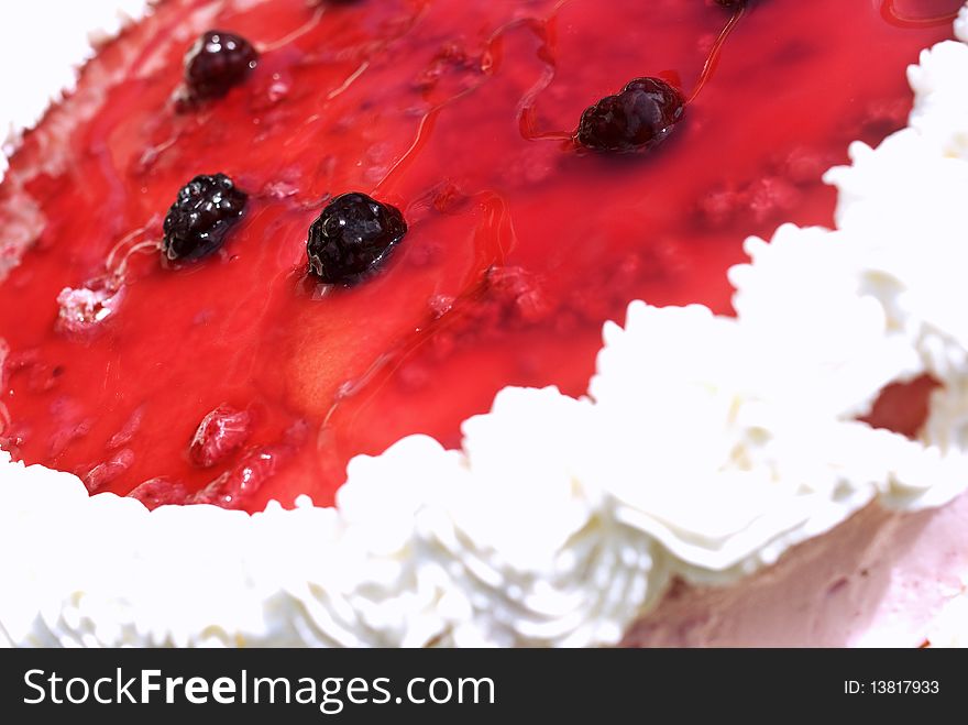 Fruit cake with forest fruit topping and whipped cream decoration