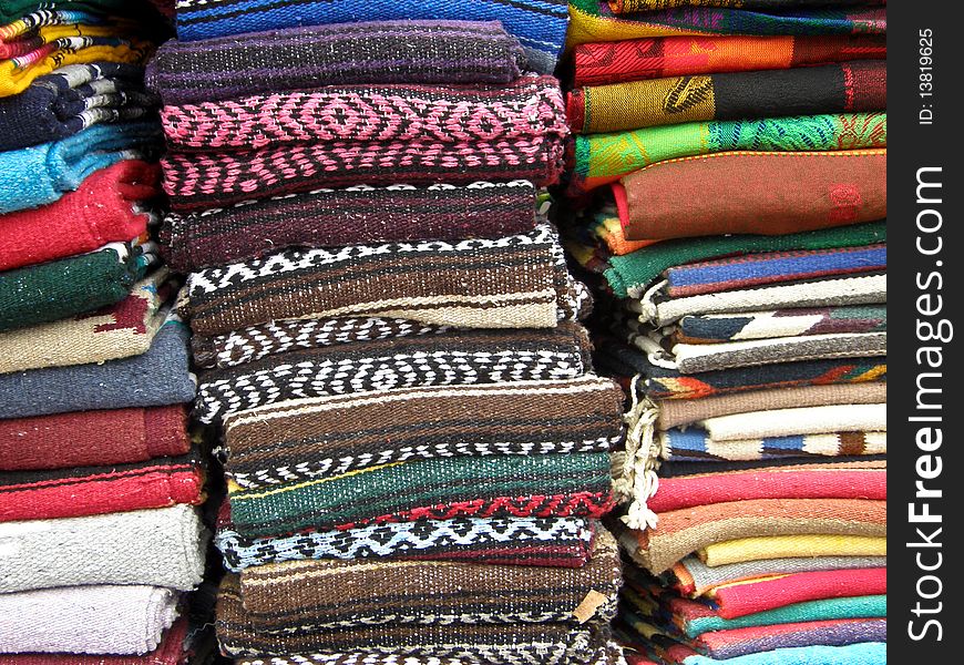 Mexican textile and tablecloths display in piles