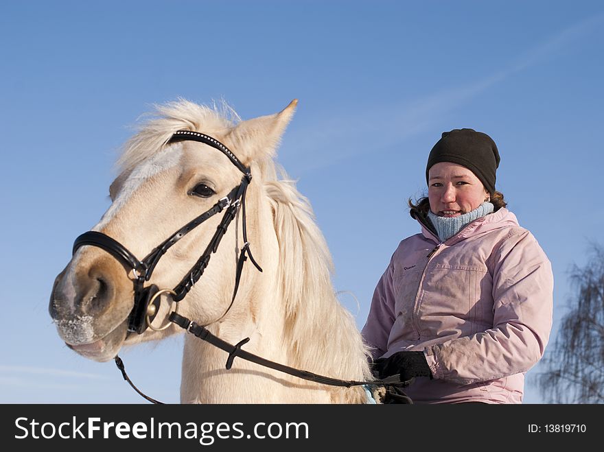 Young girl looking at camera on horseback of the white horse. Young girl looking at camera on horseback of the white horse