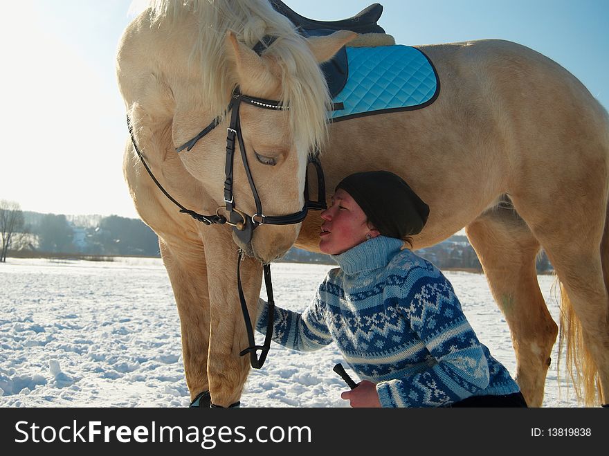 Touching and tender image of the young woman and her white horse