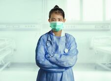 Confident And Successful Asian Korean Medicine Doctor Woman In Hospital Scrubs And Mask Posing At Clinic Patient Bed In Royalty Free Stock Photos
