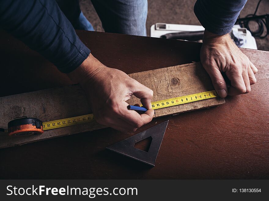 Amateur Carpenter Measures The Board