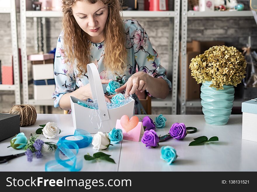 Flower Shop: Florist Girl Collects A Bouquet Of Red Roses In A Blue Paper Basket.