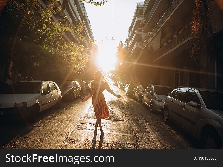 Girl dress city street cars sunset rays