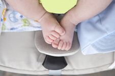 Newborn Baby Chubby Feet Over On I-size Baby Car Over Stroller Royalty Free Stock Photo