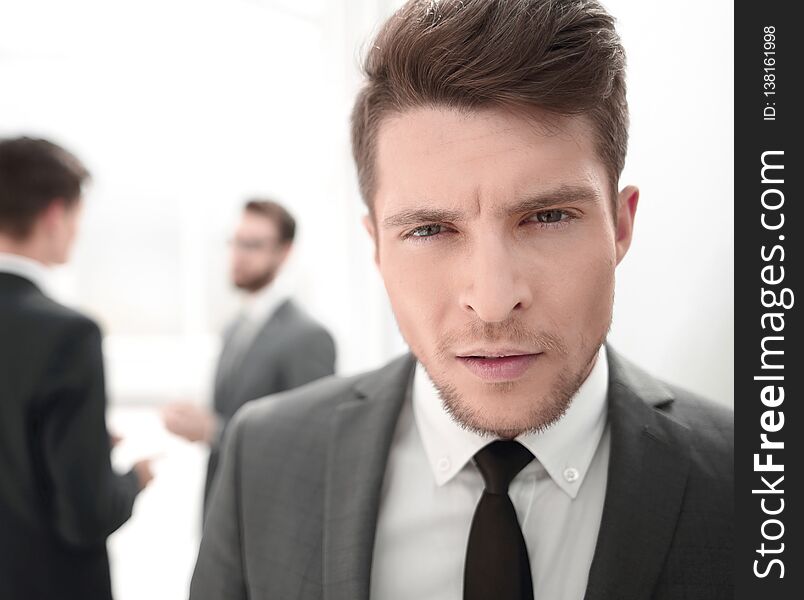 Close up.portrait of a serious young businessman on a blurred background