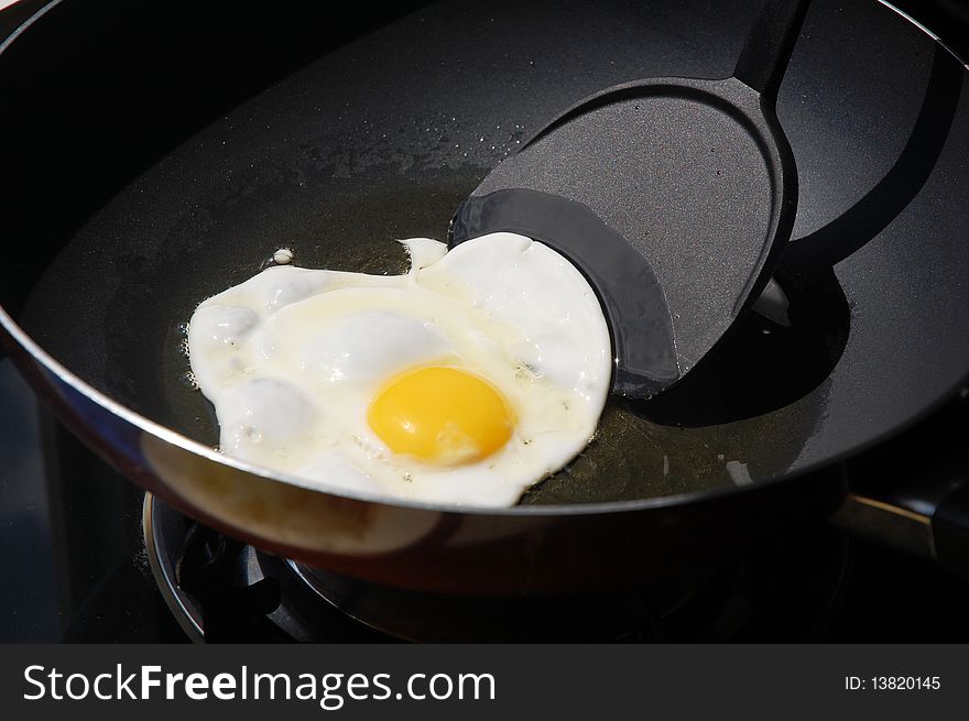 Macro closeup of an egg sizzling in a frying pan. Macro closeup of an egg sizzling in a frying pan