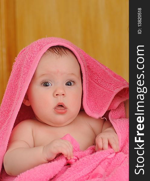 Beautiful baby In a pink towel