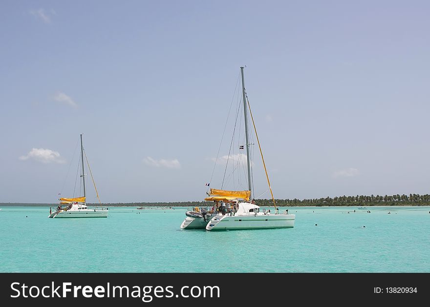 Catamarana and people swiming in caribbean sea