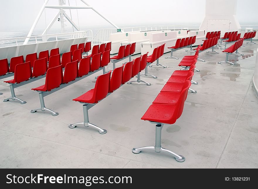 Wet red modern chairs outside