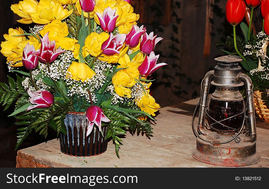 Pink and yellow tulips in vase with lantern. Pink and yellow tulips in vase with lantern