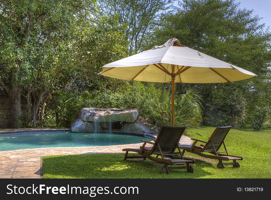 HDR image of a tranquil poolside scene. Perfect for holiday and vacation concepts. HDR image of a tranquil poolside scene. Perfect for holiday and vacation concepts.
