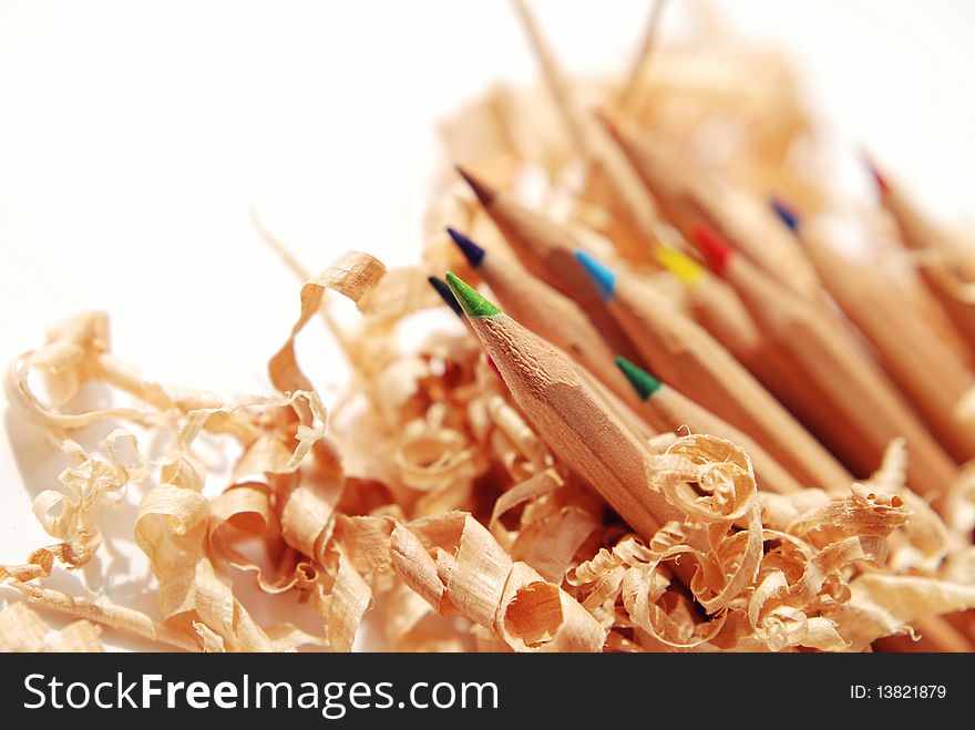 Coloured pencils with shavings isolated on a white background
