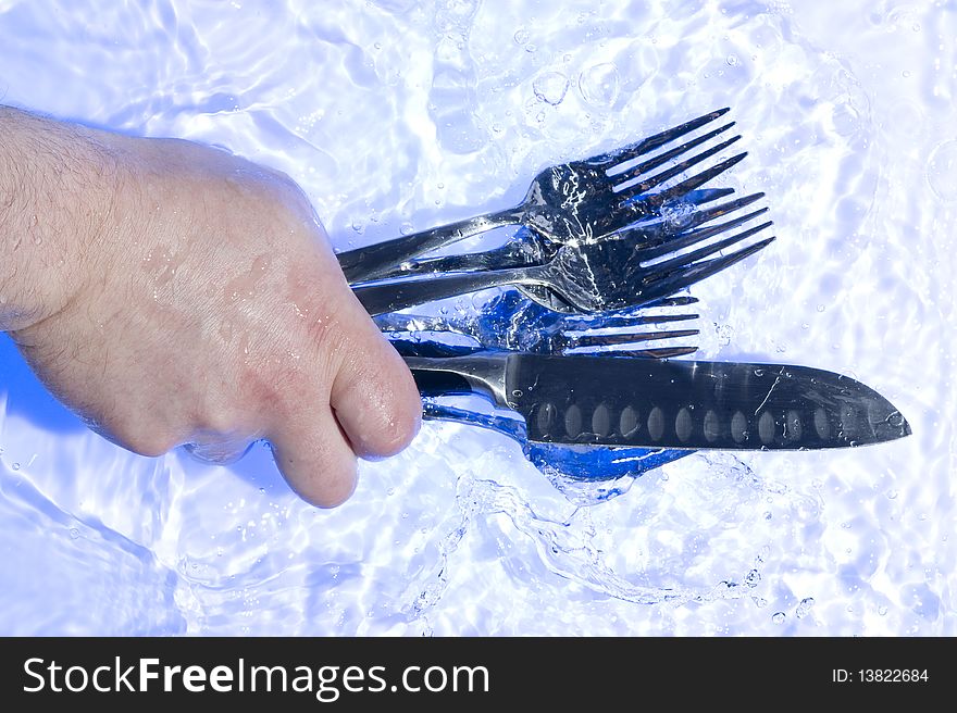 Fork with knife washing on the  water. Fork with knife washing on the  water