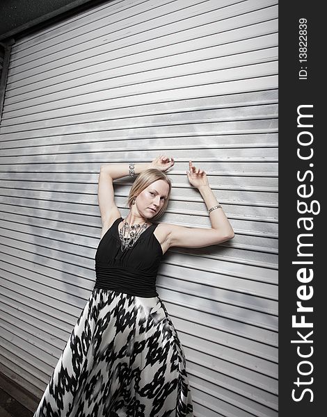 Attractive young fashion model posing in an urban setting. Attractive young fashion model posing in an urban setting