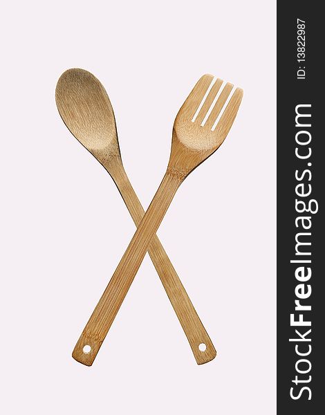 Wooden fork and spoon on a white background. Wooden fork and spoon on a white background