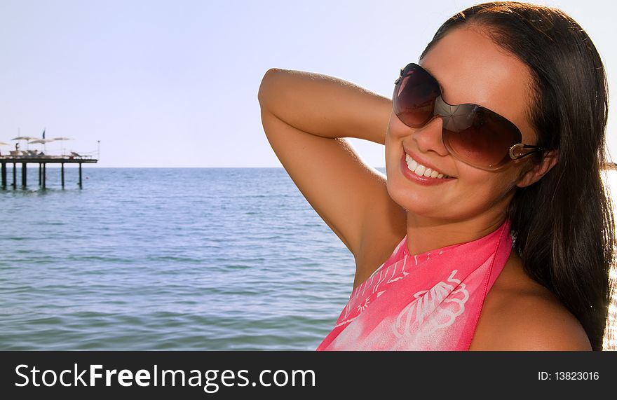 Young beautiful woman at the beach. Young beautiful woman at the beach