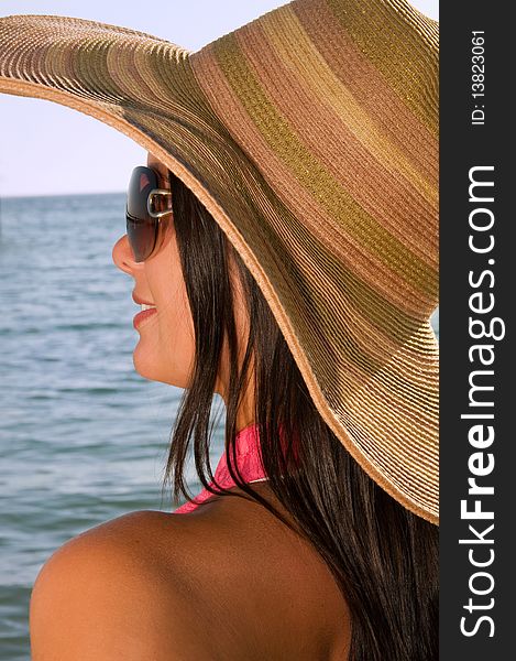 Woman standing on shoreline at the beach, summer