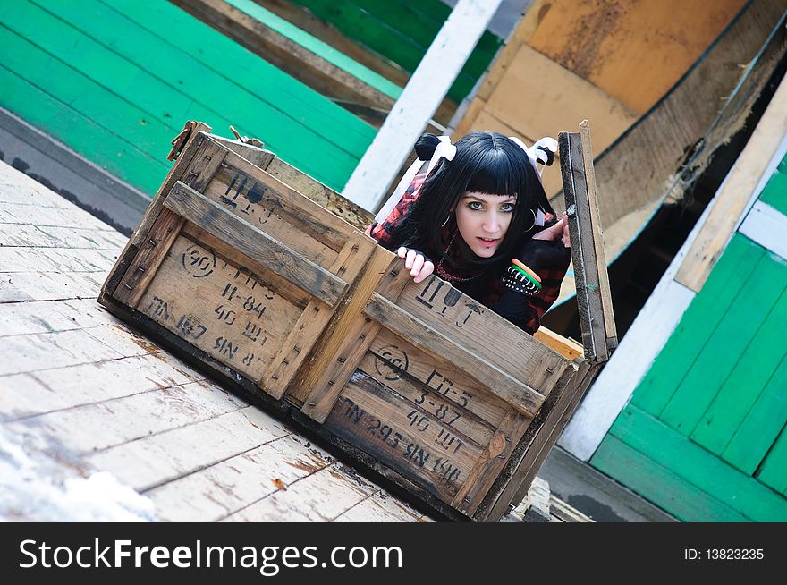 The beautiful girl gets out of the shipping container. The beautiful girl gets out of the shipping container