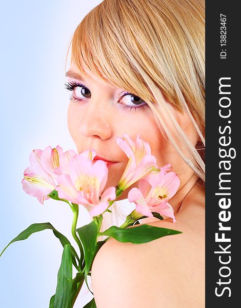 Portrait of a woman holding pink flowers over white background