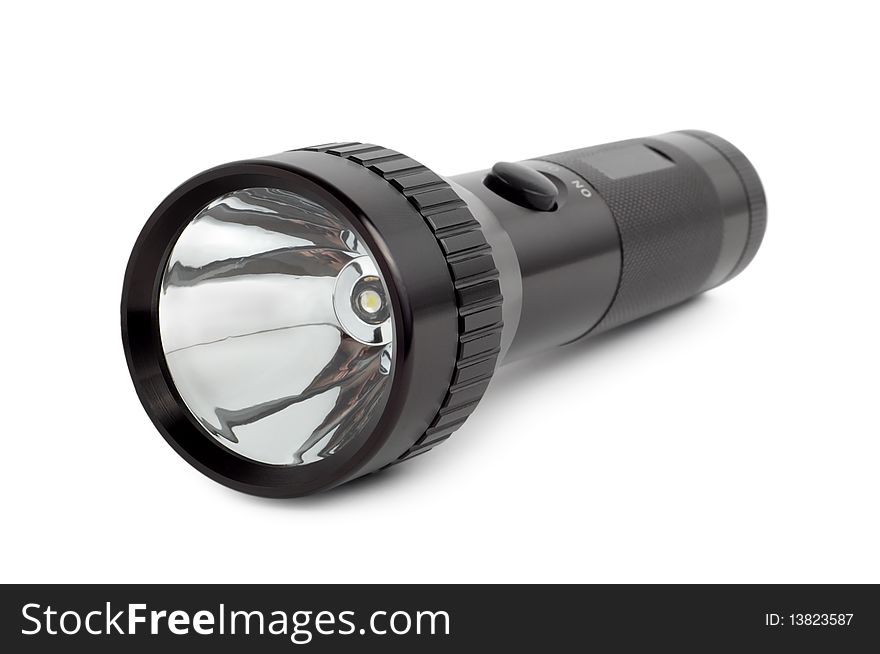 Black metallic flashlight isolated on a white background