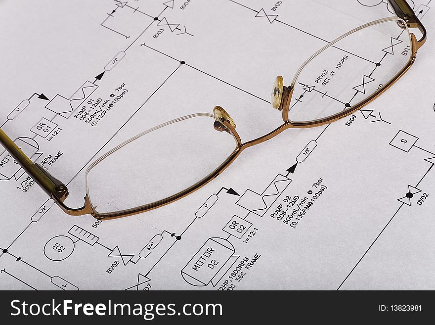 Technical drawing withe reading glasses on top. Technical drawing withe reading glasses on top