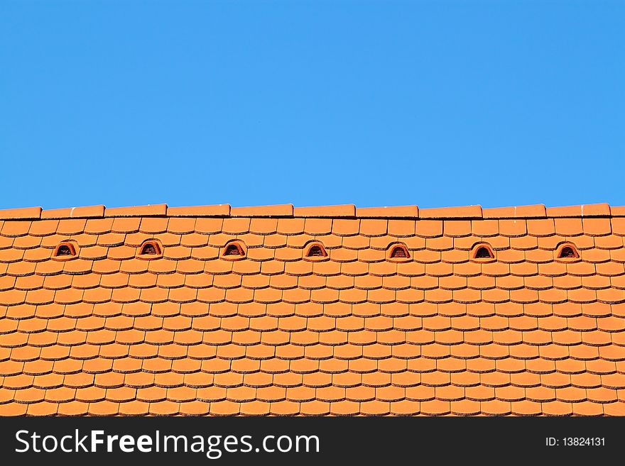 A roof top with blue sky behind it. A roof top with blue sky behind it