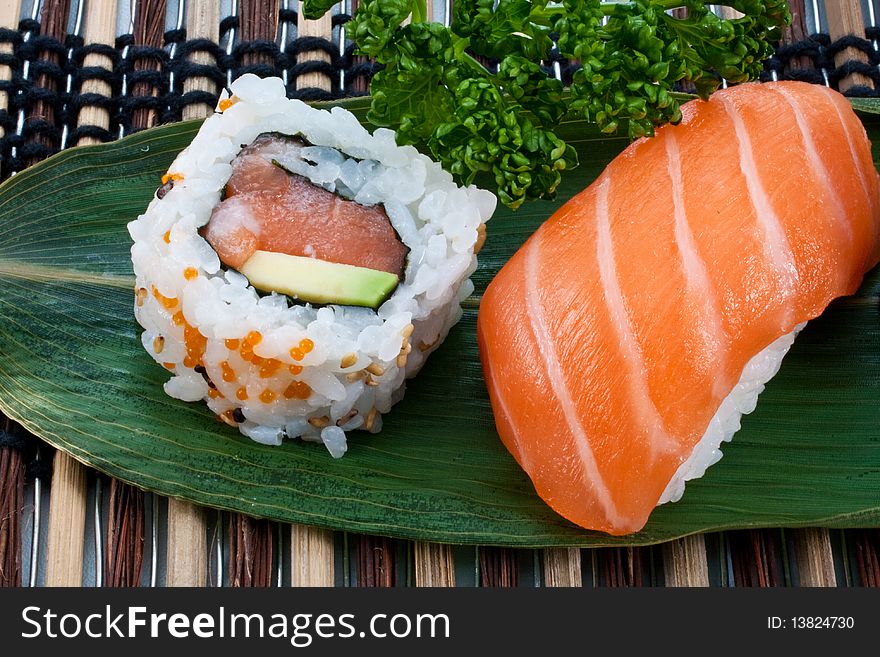 Sushi, japanese cuisine. Uramaki and nighiri, pieces on a leaf