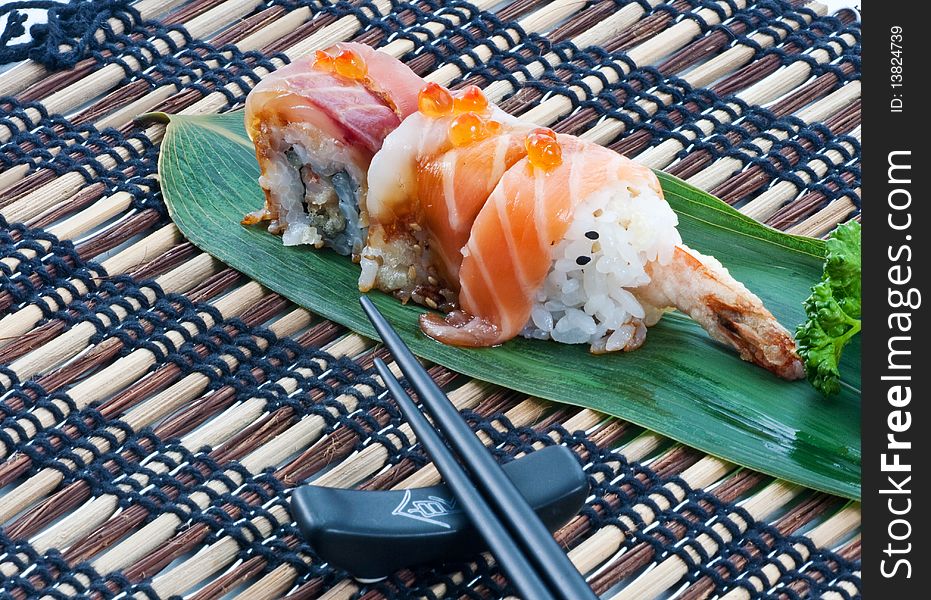 Sushi, japanese cuisine. Uramaki pieces on a leaf