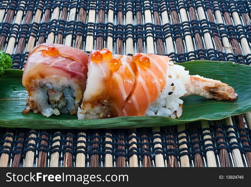 Sushi, japanese cuisine. Uramaki pieces on a leaf