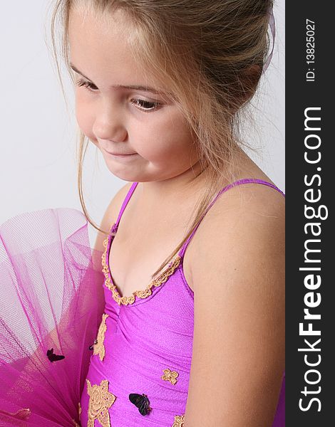 Young girl wearing a tutu dreaming of becoming a ballet dancer. Young girl wearing a tutu dreaming of becoming a ballet dancer