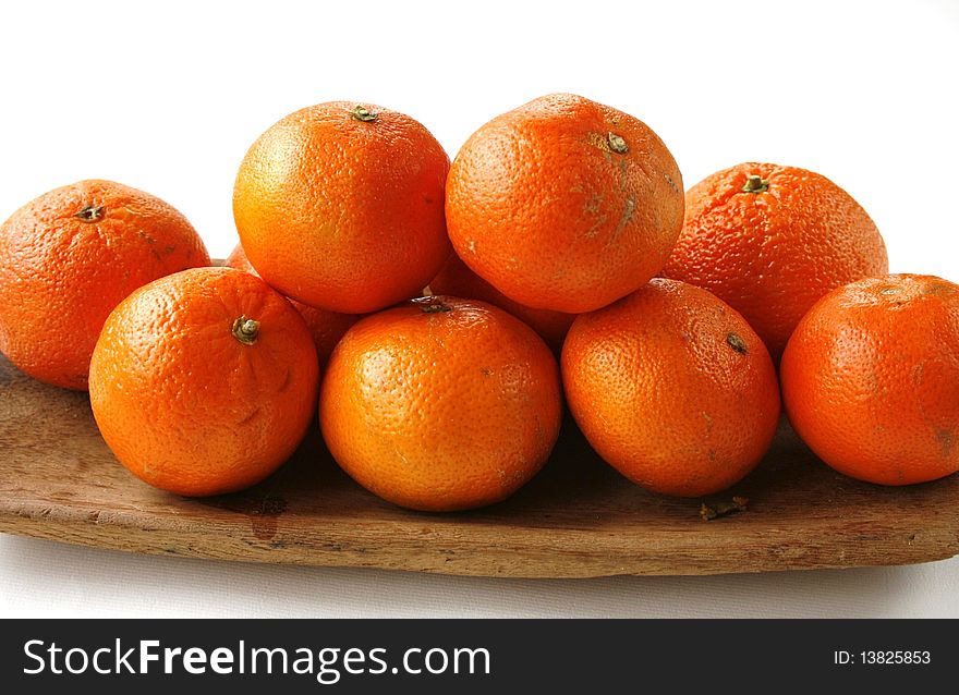 Mandarins on the wooden plate in isolated on white. Mandarins on the wooden plate in isolated on white