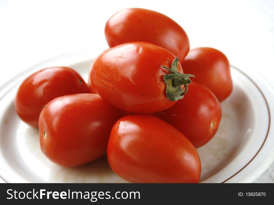 Tomatoes on the plate in isolated on white