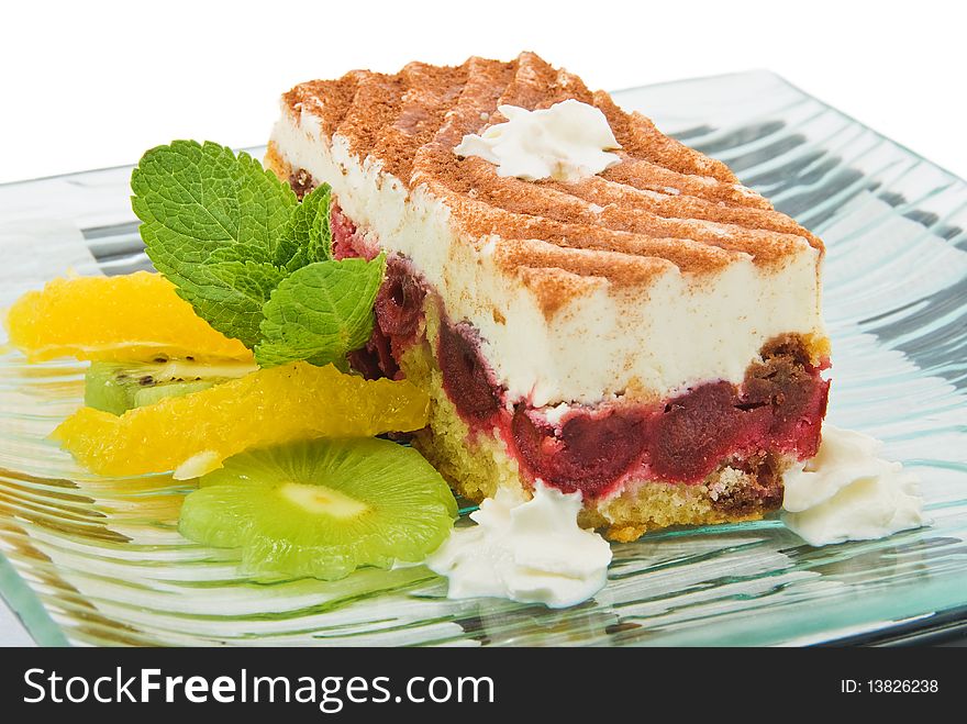 Pastry with kiwi mint and orange on plate