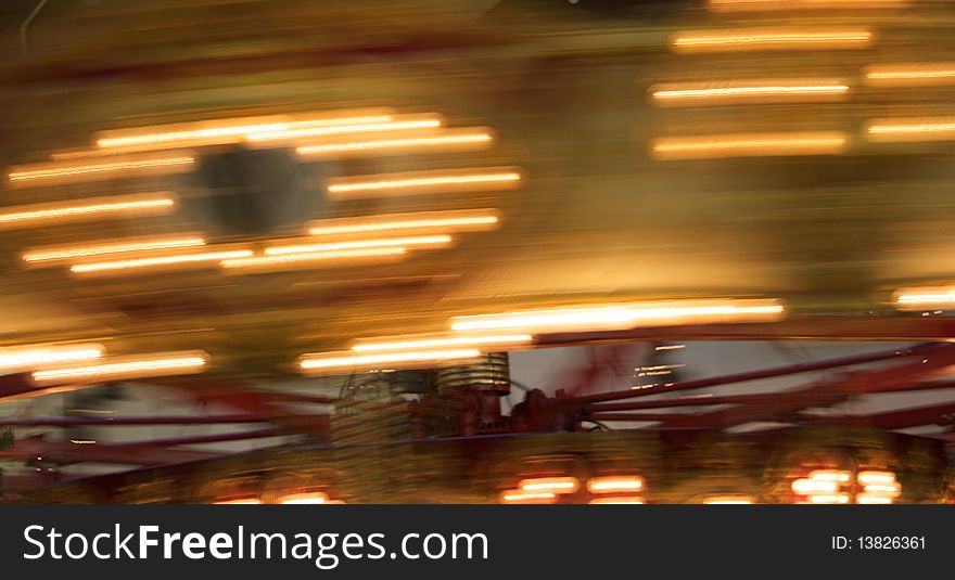 Blurred and tilted image showing merry-go-round lights in motion